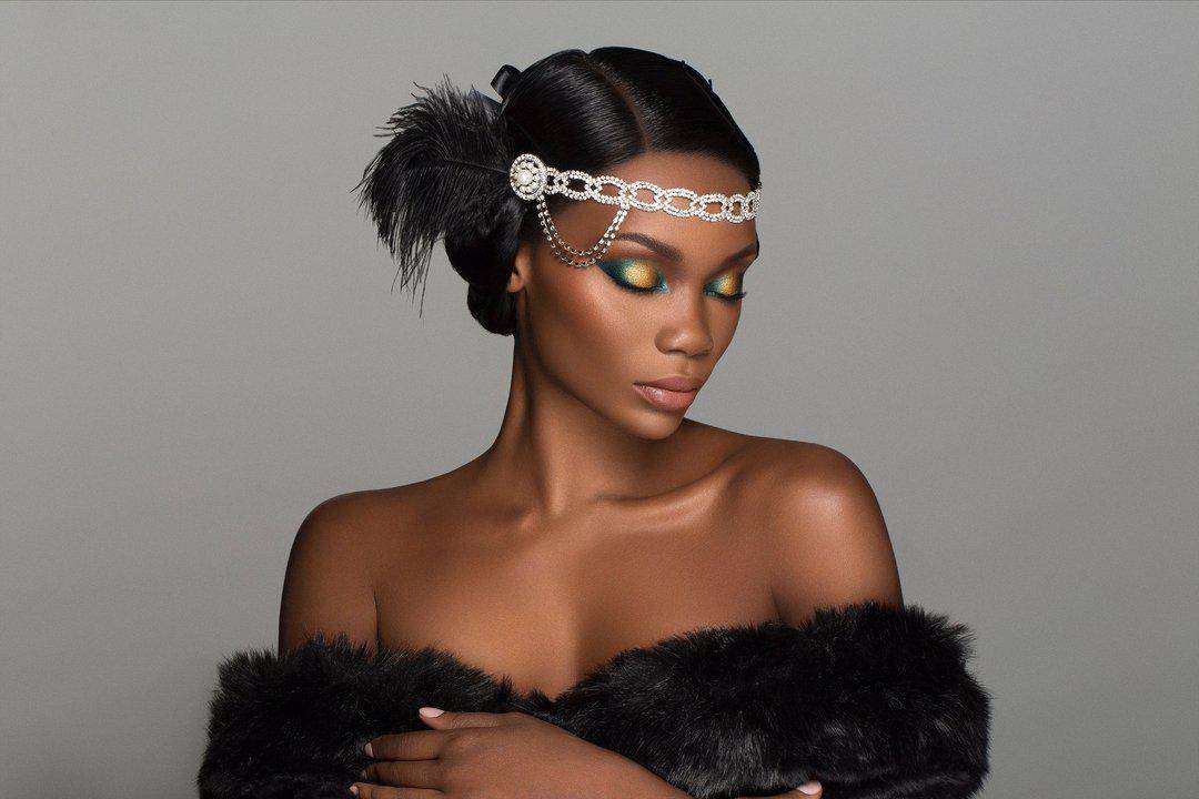 Cheers To The Beauty™ eyeshadow and highlighter palette worn on a dark-skinned model in flapper style