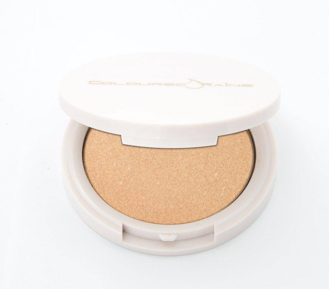 Selfie - Champagne highlighter by Coloured Raine Cosmetics. Half-open, in a white, circular, mirrored container.