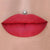 Vanity Raine red liquid lipstick with orange undertones by Coloured Raine Cosmetics